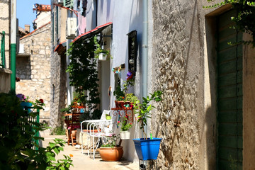 Fototapeta na wymiar Colorful narrow street in Sibenik, Croatia. Sibenik is popular summer travel destination.