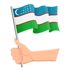 Hand holding and waving the national flag of Uzbekistan. Fans, independence day, patriotic concept. Vector illustration, eps 10.