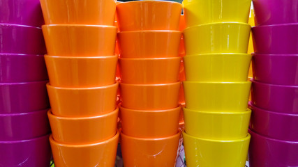 Stacks of colorful ceramic flower pots.
