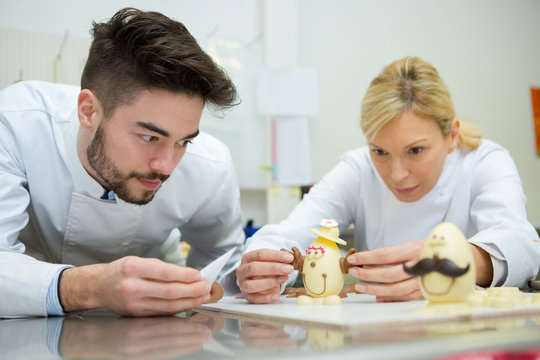 confectioner making amusing faces on cholocate eggs