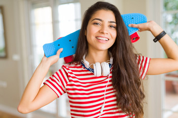 Beautiful skater woman smiling friendly standing with skateboard