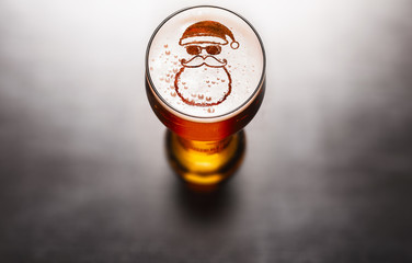 Christmas or New Year beer concept. Star symbol on beer glass foam on black table, view from above - 270383466