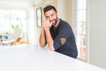 Handsome man smiling cheerful with a big smile on face showing teeth, positive and happy expression