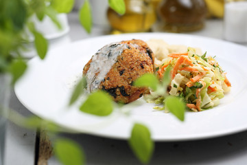 Vegetarian lunch, healthy vegetable cutlet with dumplings and white cabbage salad.