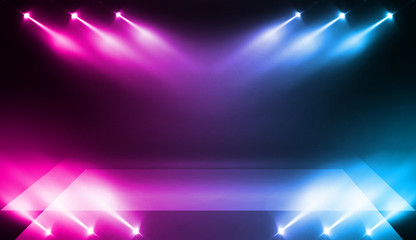 Background of empty stage show. Neon blue and purple light and laser show. Laser futuristic shapes on a dark background. Abstract dark background with neon glow