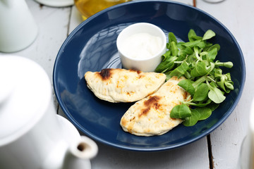 Calzone with spinach filling served with garlic sauce.