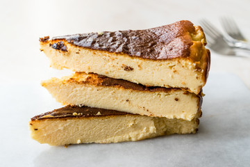 San Sebastian Cheesecake Slice on Marble Surface / Creamy Plain New York Style.