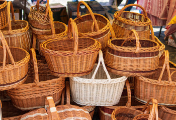 Picnic baskets on the street in stacks for sale.