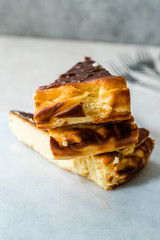 San Sebastian Cheesecake Slice on Marble Surface / Creamy Plain New York Style.