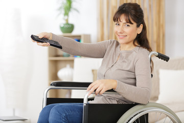 handicapped woman pressing the remote