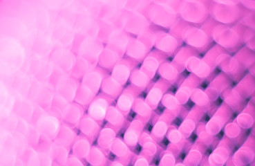 Abstract blurred pink background. Texture of a metal mesh.