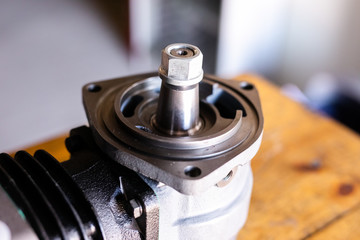 Mechanic repairs old motor of truck in a car repair station. Disassemble engine block vehicle. New details for motor. Car service concept