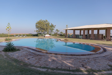 Pool and clubhouse with no people at Reggie's camel camp in Osian Jodhpur Rajasthan India