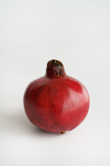 Organic whole pomegranate. White background, high resolution