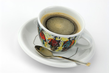 A cup of coffee in a colored cup on gray background