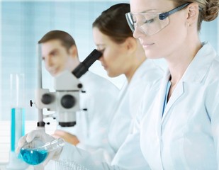 Young Female Scientist Working with Microscope