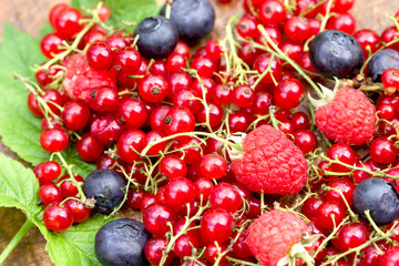 Organic forest berry fruit on rustic wooden table closeup
