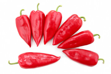 seven bright red sweet peppers on a white background