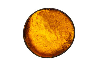Turmeric powder in wooden bowl isolated on white. Top view overhead shot