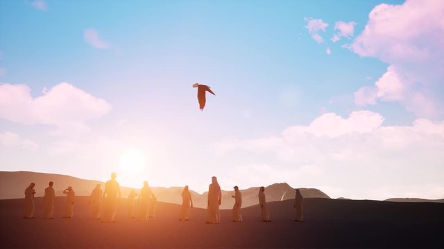 Sunset silhouette Arabic men with bird of prey on desert sands