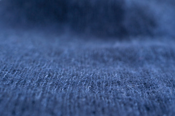Fototapeta na wymiar dark blue knitted background woolen pattern wallpaper handmade