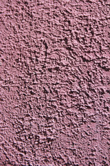 rough pink surface of old a wall with cracks and stains
