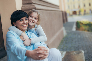 little girl hugging her mother outdoor