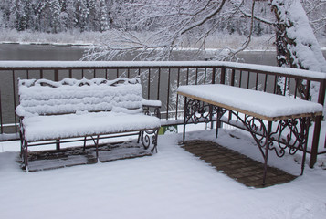 Suddenly there was a big snowfall. The benches were covered with a layer of snow.