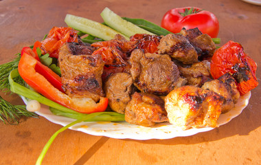 barbecue in a plate with vegetables