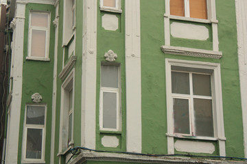 Kadıköy is a neighborhood famous for historical houses and buildings scattered around. Green haouse with white ornaments.