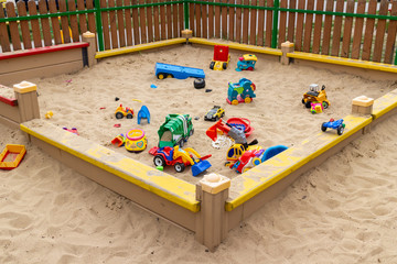 Children colorful toys in the sandbox - 270393694