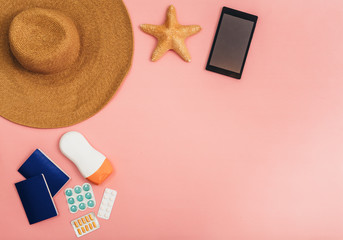 flat lay summer vacation items on pink background