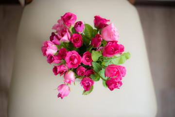 Fresh roses on chair vintage chair.