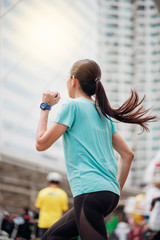 Beautiful asian woman running in city. Sport Concept