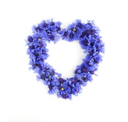 blue flowers cornflowers pattern wreath, frame, a circle in heart form on white background. top view. copy space