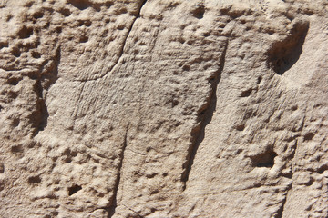 texture rough brown gray surface of an old cement wall with cracks, patterns and divorces
