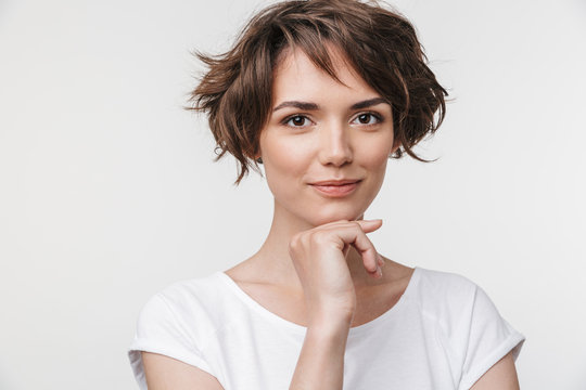 Portrait of cute woman with short brown hair in basic t-shirt looking at camera