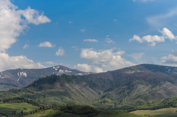 Landscape on the spring mountains, on which tops there is still snow