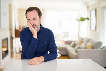 Handsome middle age man at home thinking looking tired and bored with depression problems with...
