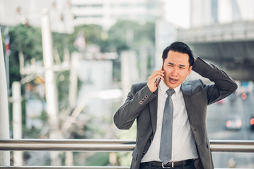 Fototapeta premium Serious businessman using mobile phone