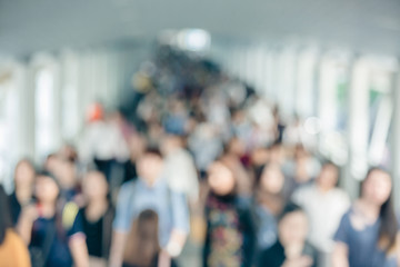 many people walking on the skywalk with blurry image, lifestyle in city