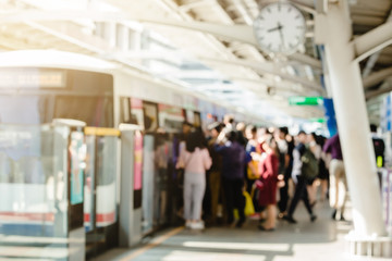 Blurry of people getting on and getting out electric skytrain with automatic gateway