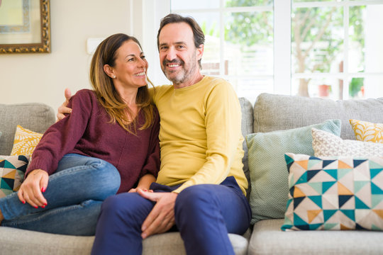 Middle Age Romantic Couple Sitting On The Sofa At Home