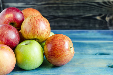 apples red and green on wooden background