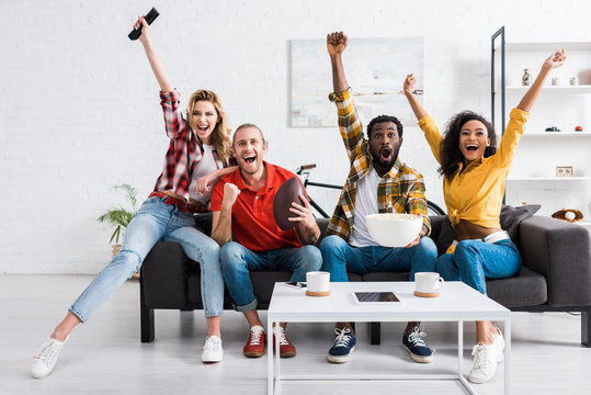 Happy Multicultural Friends Watching Sport Match And Having Fun Together