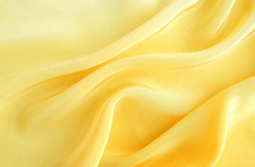 Fototapeta premium silk fabric texture, background pastel yellow color . copy space