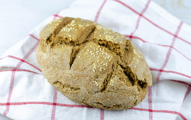 fresh rustic whole wheat bread baked at home, bio ingredients, very healthy with sesame