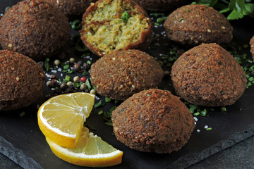 Falafel with spices on a stone board.