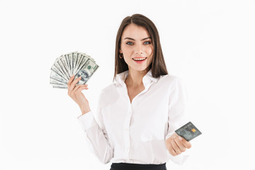 Photo of caucasian female worker businesswoman dressed in formal wear holding cash money and credit card while working in office