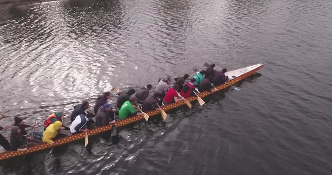 Aerial view of a team of rowers training in a rowing canal. Professional water sportsmen on a small river. Top-down view on rowing athletes Rowing teams compete with each other. 4K SHOT.